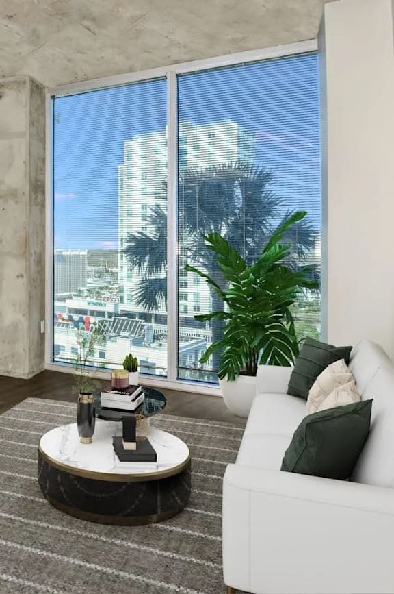 a living room with a tv and a large window at Element, Tampa, 33602