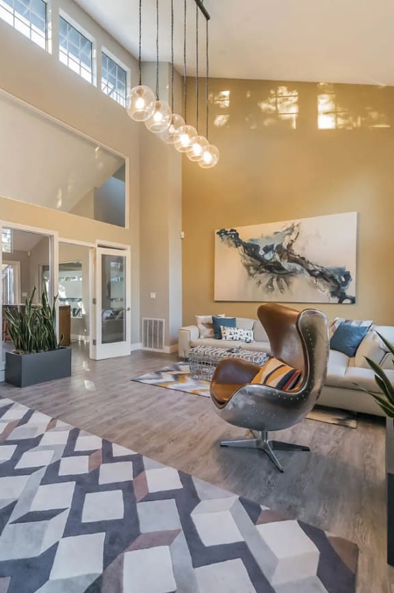 a living room with a couch and a chair and a rug