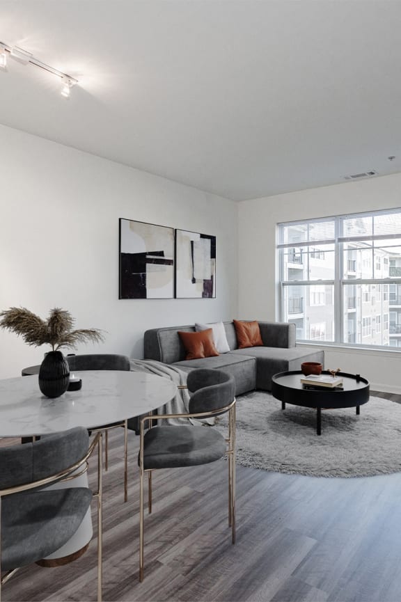 a living room with a table and chairs and a couch