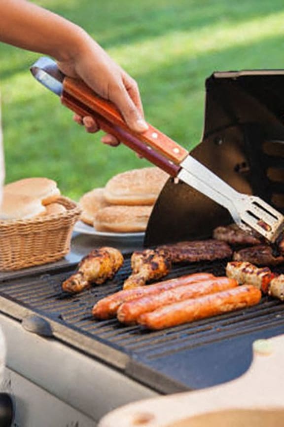 a person is grilling food on a grill