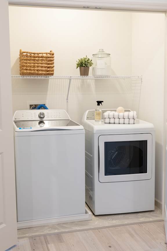 A white microwave oven is placed next to a white dishwasher.