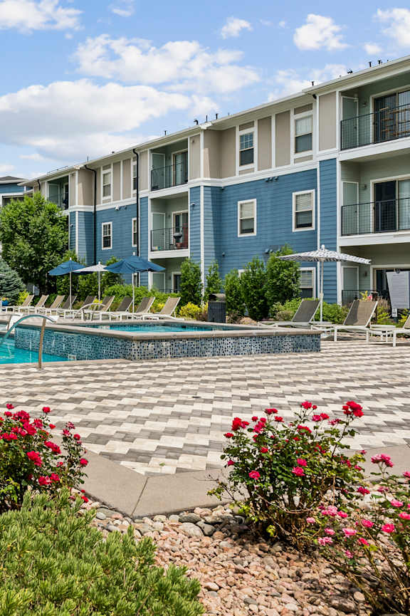 a swimming pool in front of an apartment building