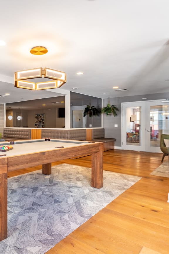 a pool table in a living room with a blue couch at Valley and Bloom, New Jersey