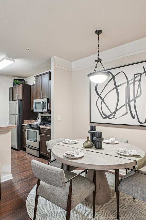 a dining room and kitchen with a table and chairs