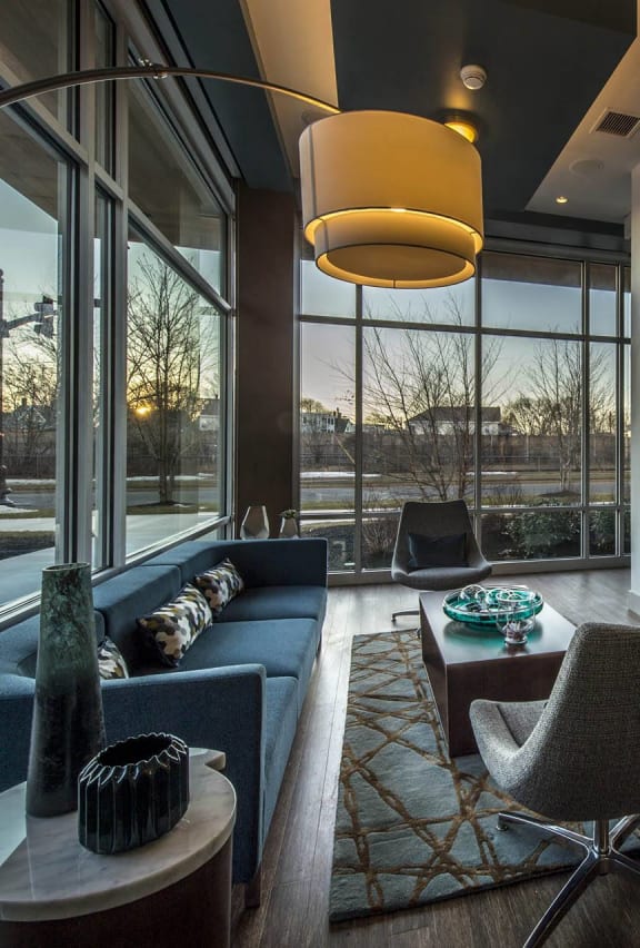 a living room with a large window and a table with chairs