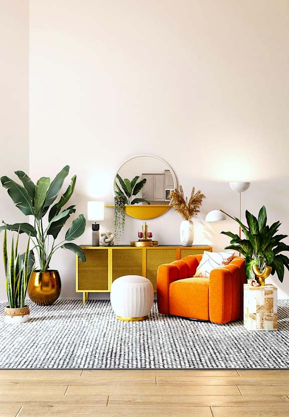 A living room with a yellow chair, a potted plant, and a rug.