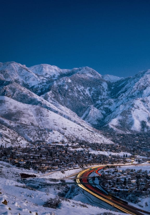 a highway winding through a snow covered mountain range