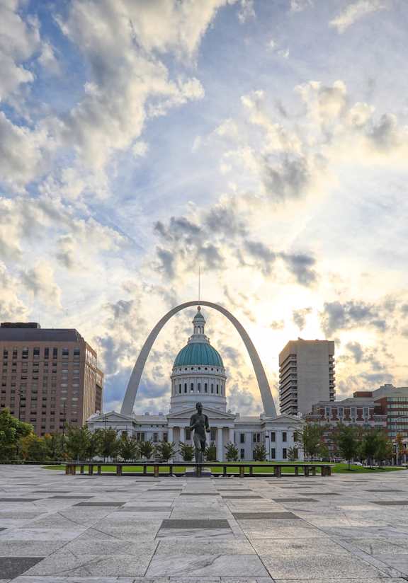 A cityscape with a large arch in the background.