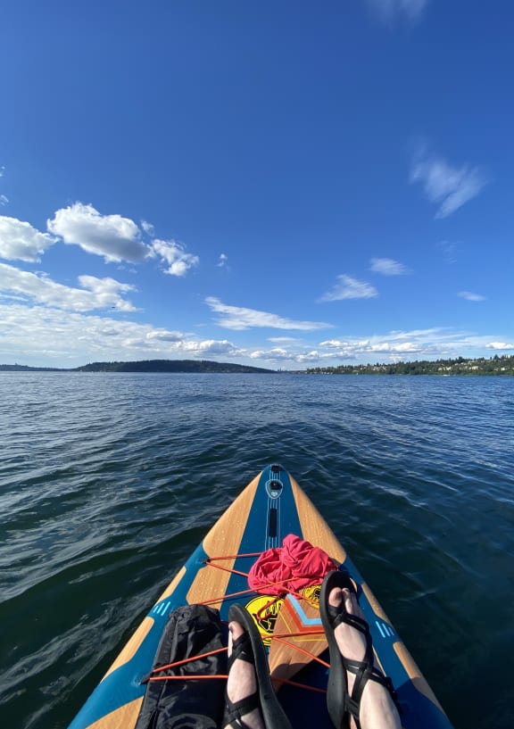a kayak in the water and a boat in the sky