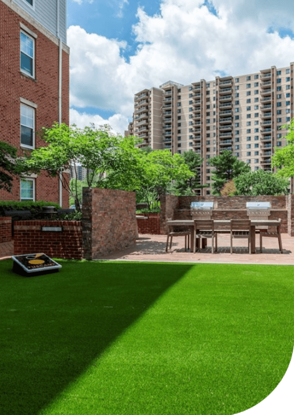 a backyard with a lawn and a picnic table