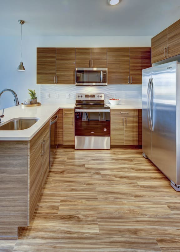 a kitchen with wooden cabinets and stainless steel appliances