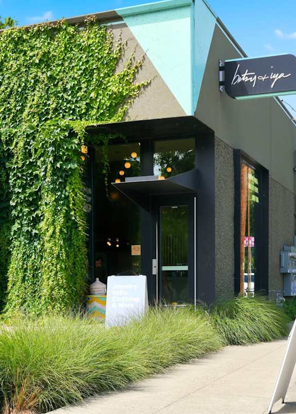 A building with a green plant on the side and a sign that says "Bakery".