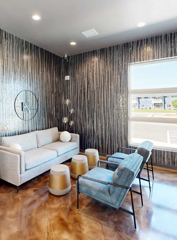 a living room with a couch and chairs and a fireplace