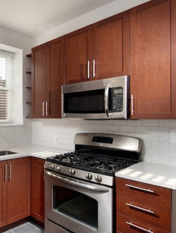a kitchen with a stove microwave and cabinets