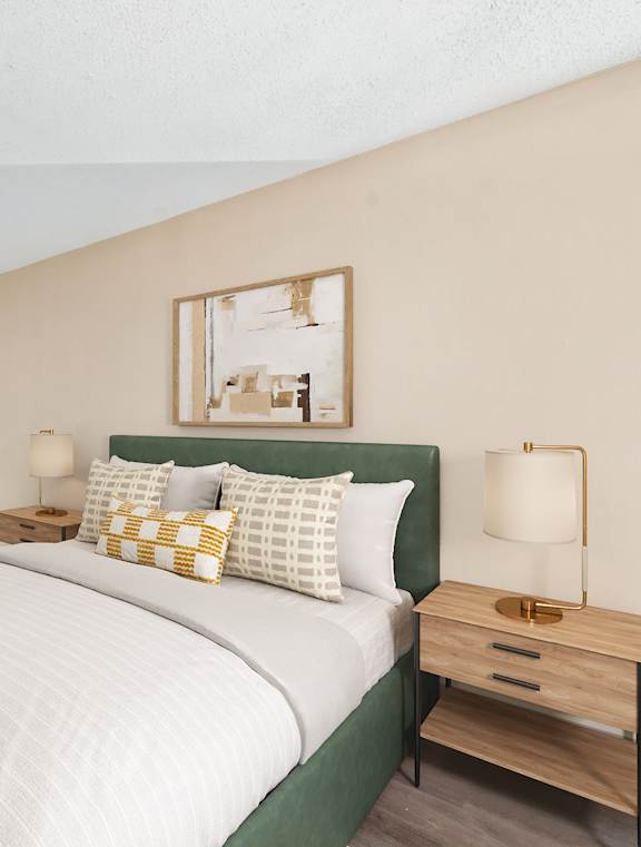 A bedroom with a large bed and a window overlooking the ocean.