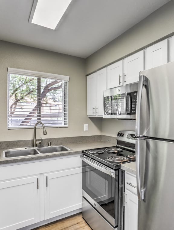 a kitchen with stainless steel appliances and a sink