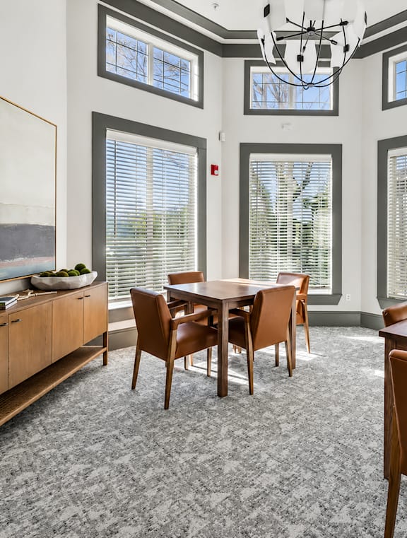 A dining room with a table and chairs.