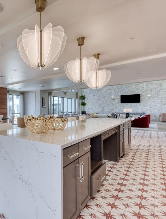 a large kitchen with a marble counter top and a dining room