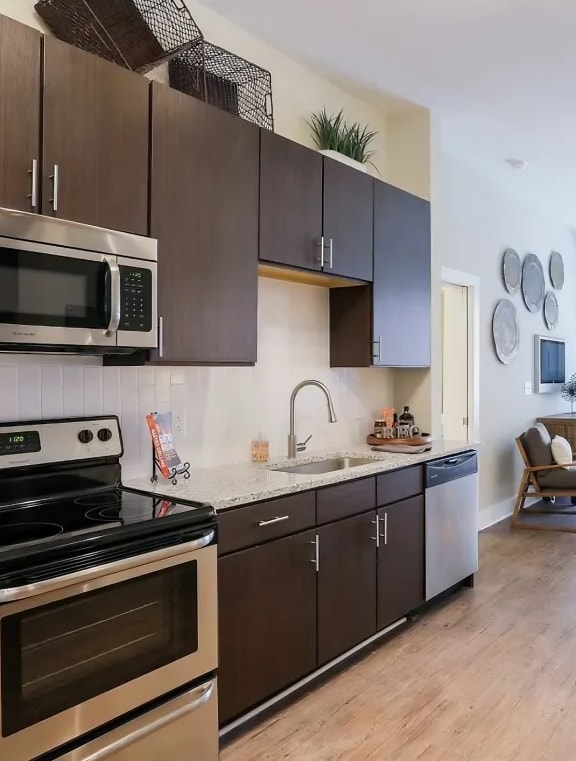 a kitchen with an island and red bar stools