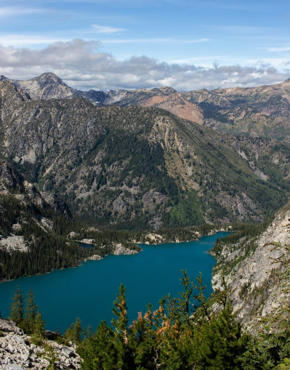 a view of the lake from the top of a mountain