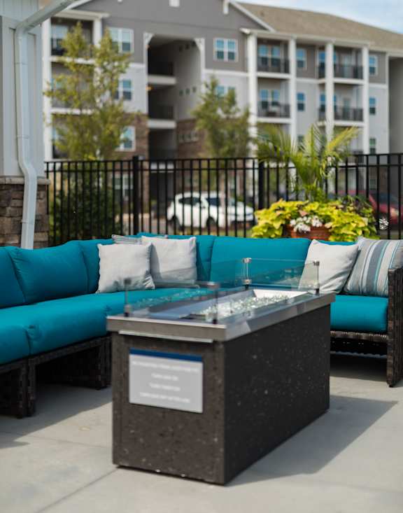 A black and silver fountain in the middle of a patio.