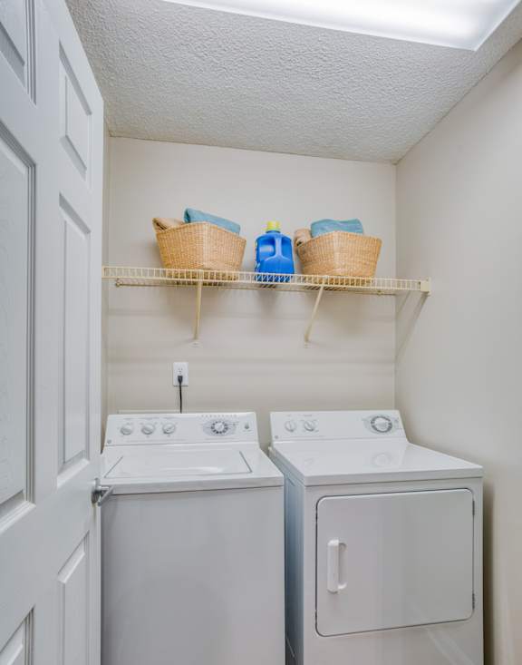 A small laundry room with a washer and dryer.