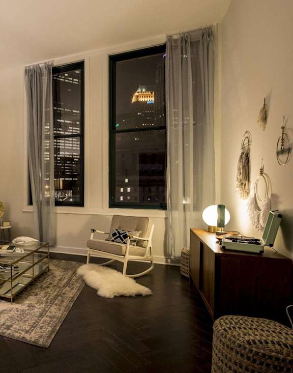 A well-lit living room with a dining table and chairs. at The Pennsylvanian Apartments, Pittsburgh, Pennsylvania
