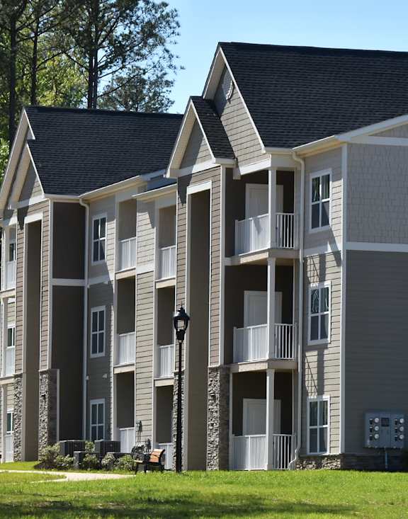 Apartment building with a black lamp post in front.