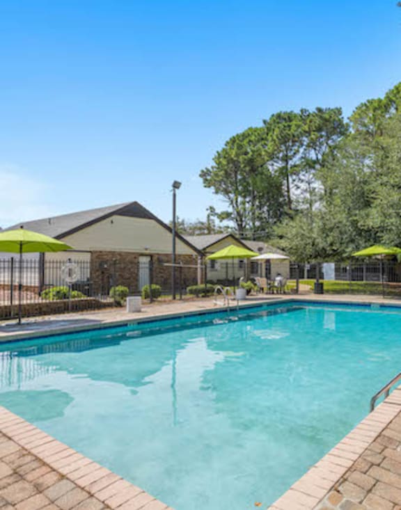 Pool and sundeck with lounge furniture at The Onyx Hoover Apartments