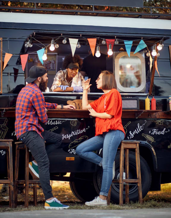 people sitting at a food truck
