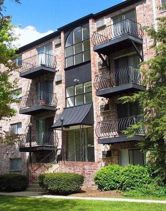 A red brick building with balconies and windows.