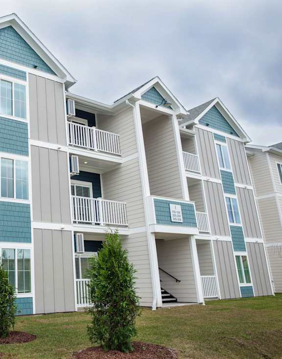 A large apartment complex with multiple balconies and windows.