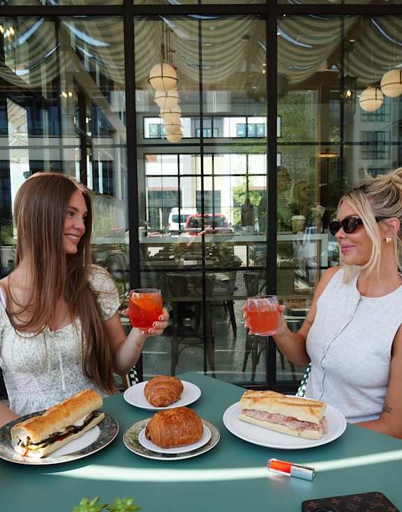 Two women enjoying drinks at Plaza at Pinnacle Hills, Rogers