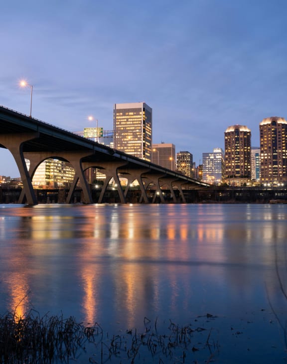 a view of the city from under a bridge over a river
