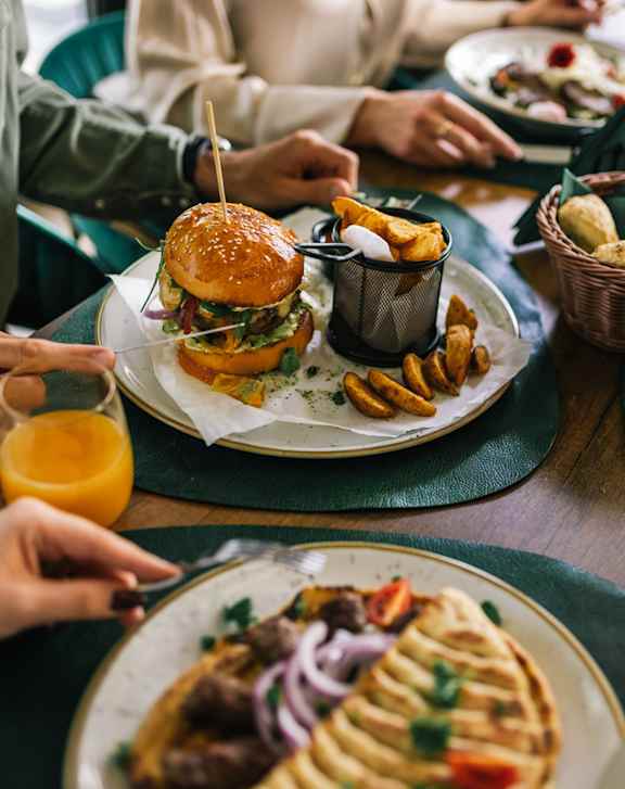 A group of people are enjoying a meal together at a restaurant.