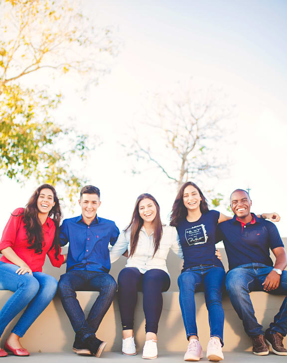 a group of people sitting on a wall