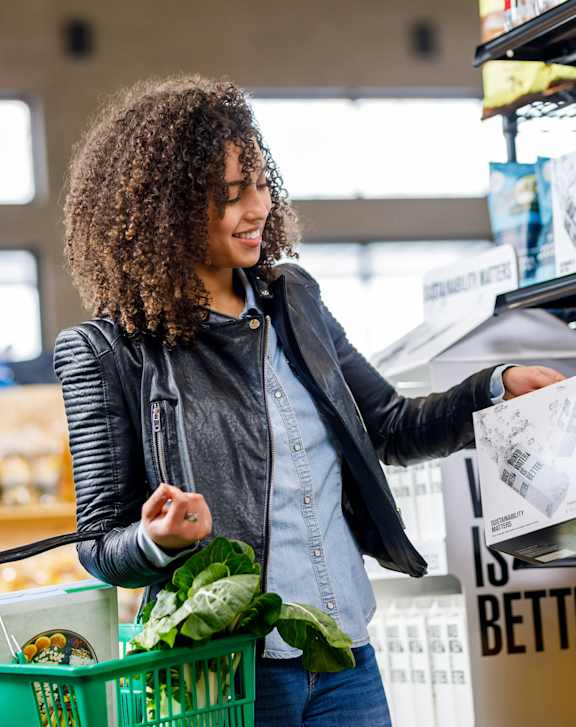 A woman is shopping for groceries in a market.