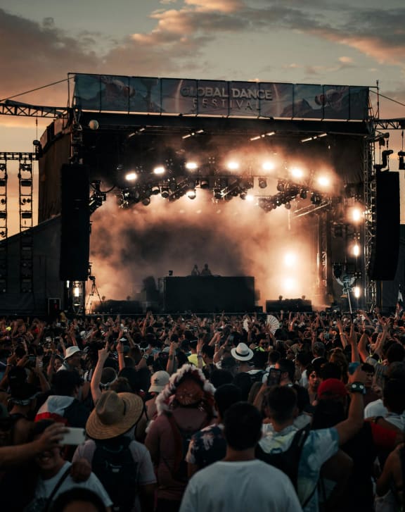 a crowd of people watching a concert on a stage