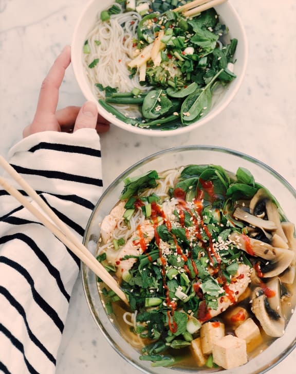 a bowl of noodle soup with a pair of chopsticks