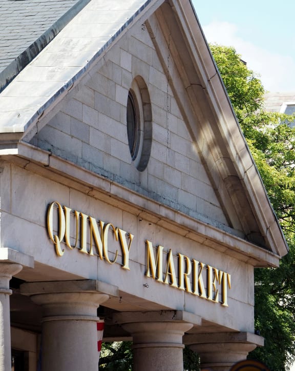 a quincy market sign on the front of a building