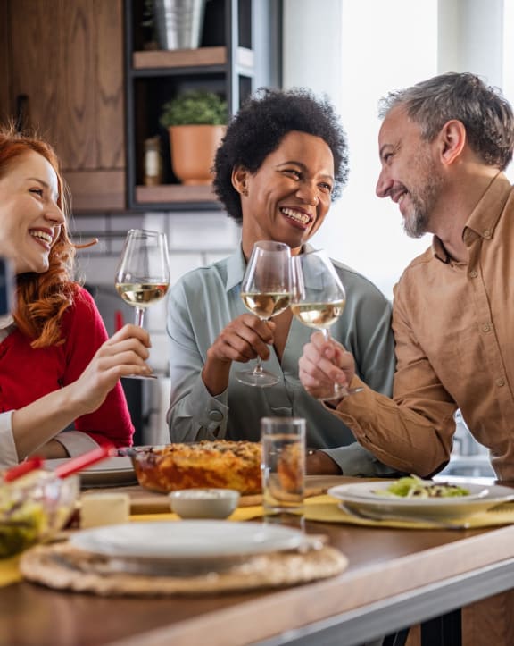 a group of people sitting around a table drinking wine at Wendover River Oaks, Greensboro, 27409