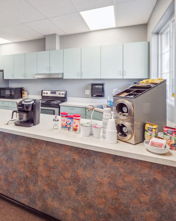 a kitchen with stainless steel appliances and a counter with a washing machine