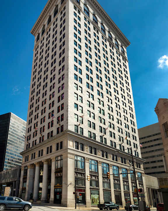 A tall building with a lot of windows is in the center of the image.