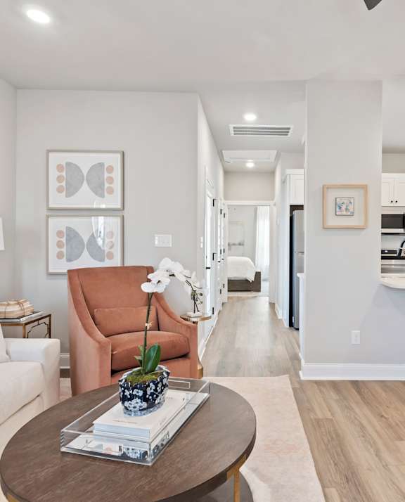 A living room with a brown chair and a coffee table. at Ovation at Town Madison, Madison