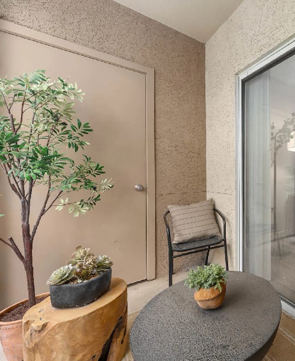 A living room with a glass door leading to a kitchen.