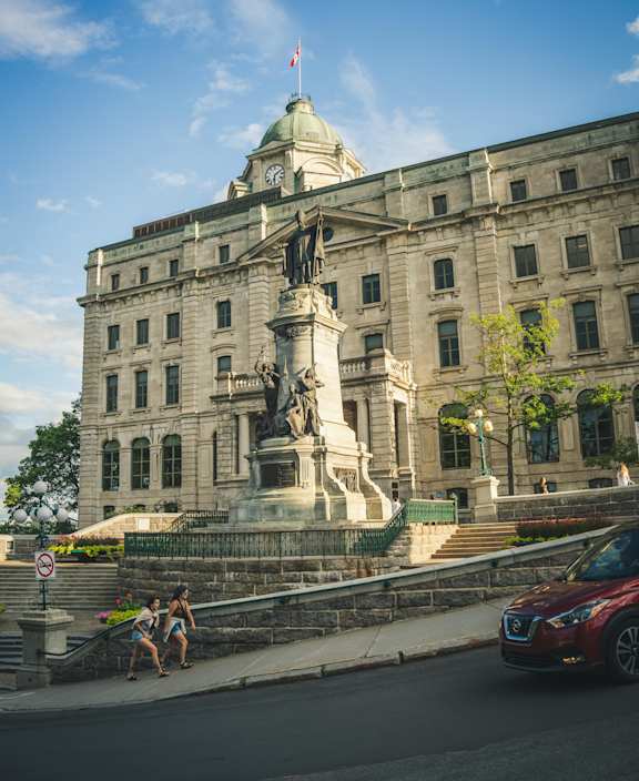 a large building with a statue in front of it