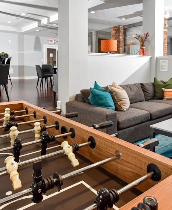A living room with a brown couch, a green chair, and a coffee table.