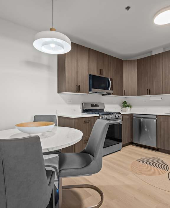 A modern kitchen with a dining table and chairs.