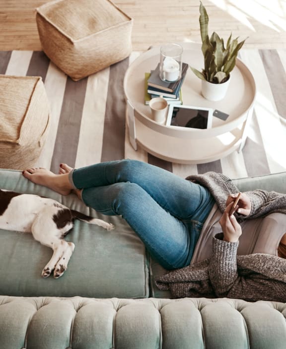 Woman and Dog sitting on couch at The Morgan, Lafayette, CA, 94549