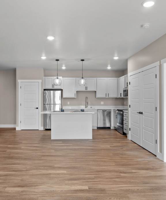 A top-down view of a small apartment with a kitchen, living room, and bathroom.